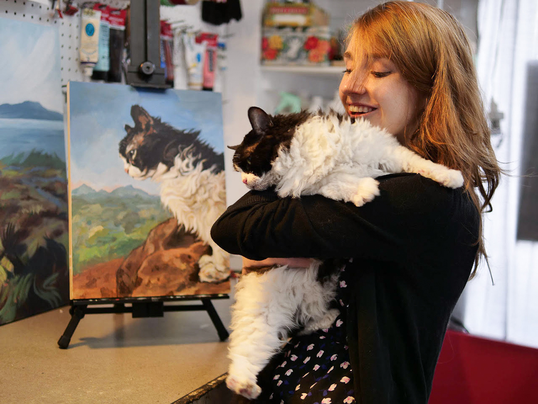 Ruby Rex Cat with her portrait at North Park Art Studio